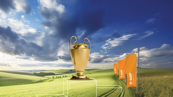 stupně vítězů, pohár a vlajky BASF v obilném poli